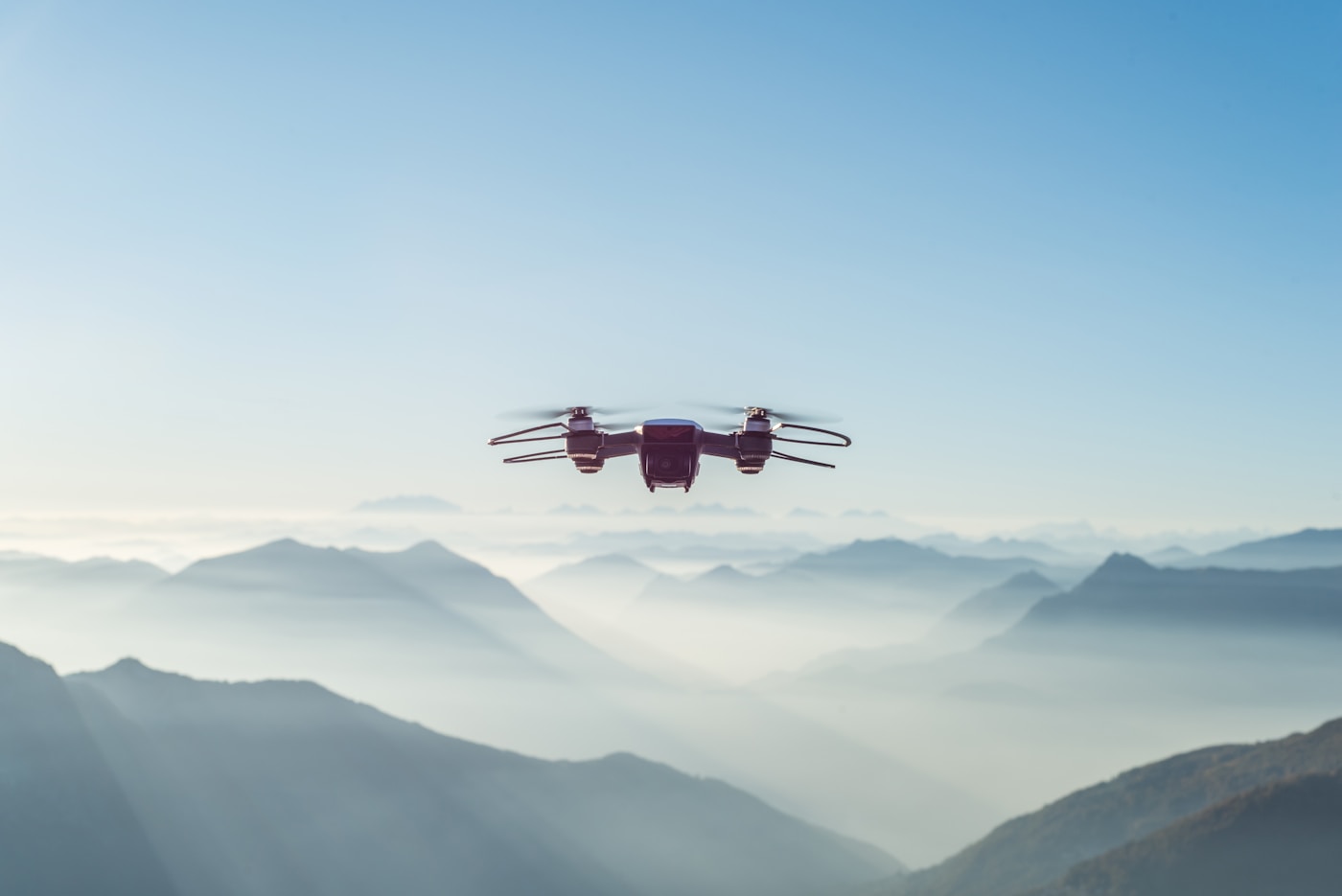 Drone flying over misty mountain landscape