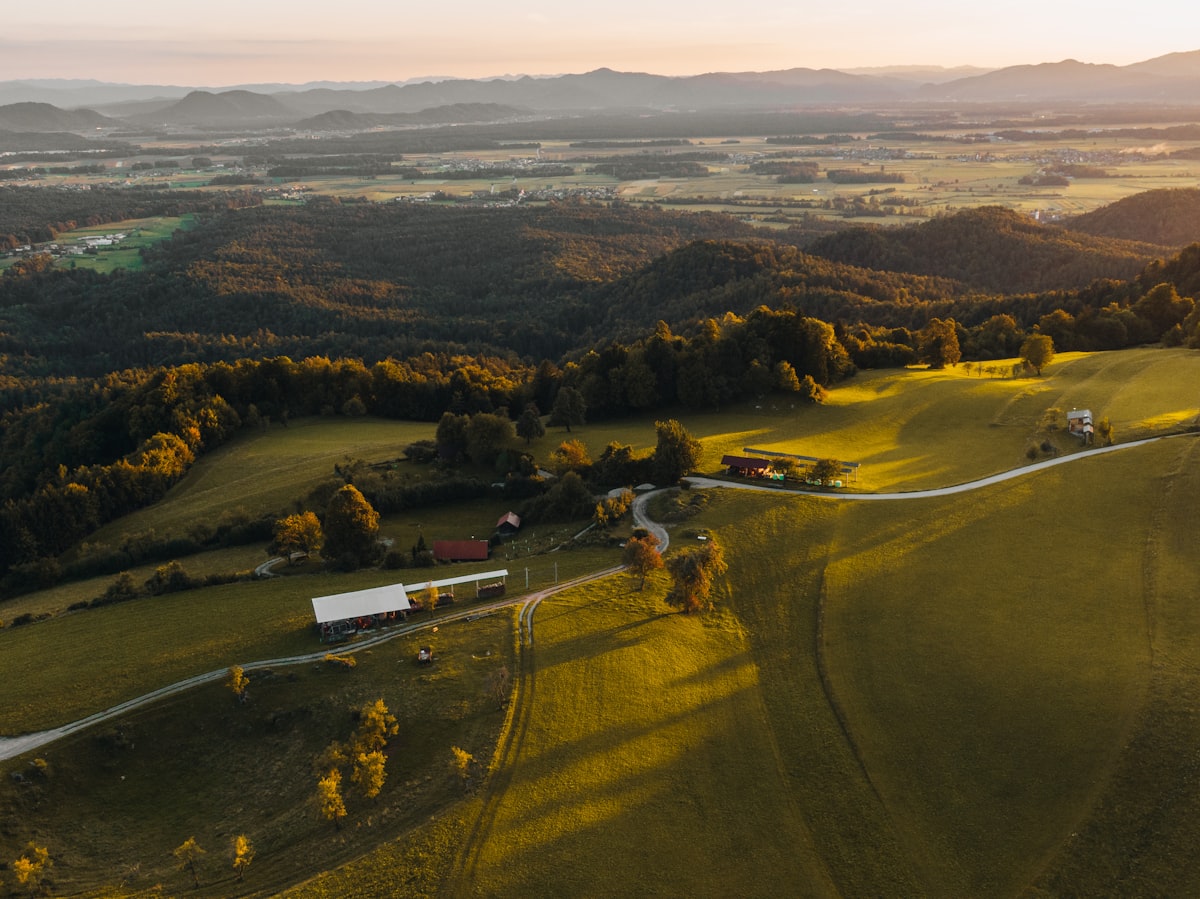 Aerial view of rolling hills and farmland — terrain DronePoint follows